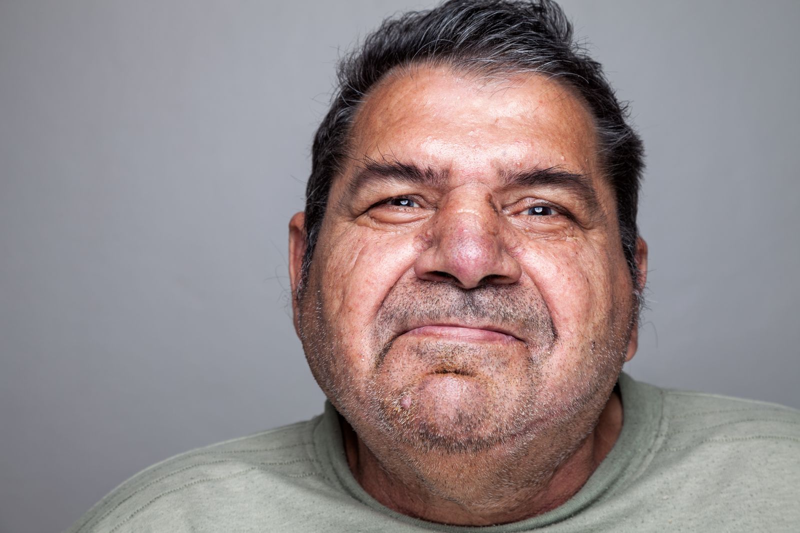 Portrait of a man in his early sixties looking directly at the camera.